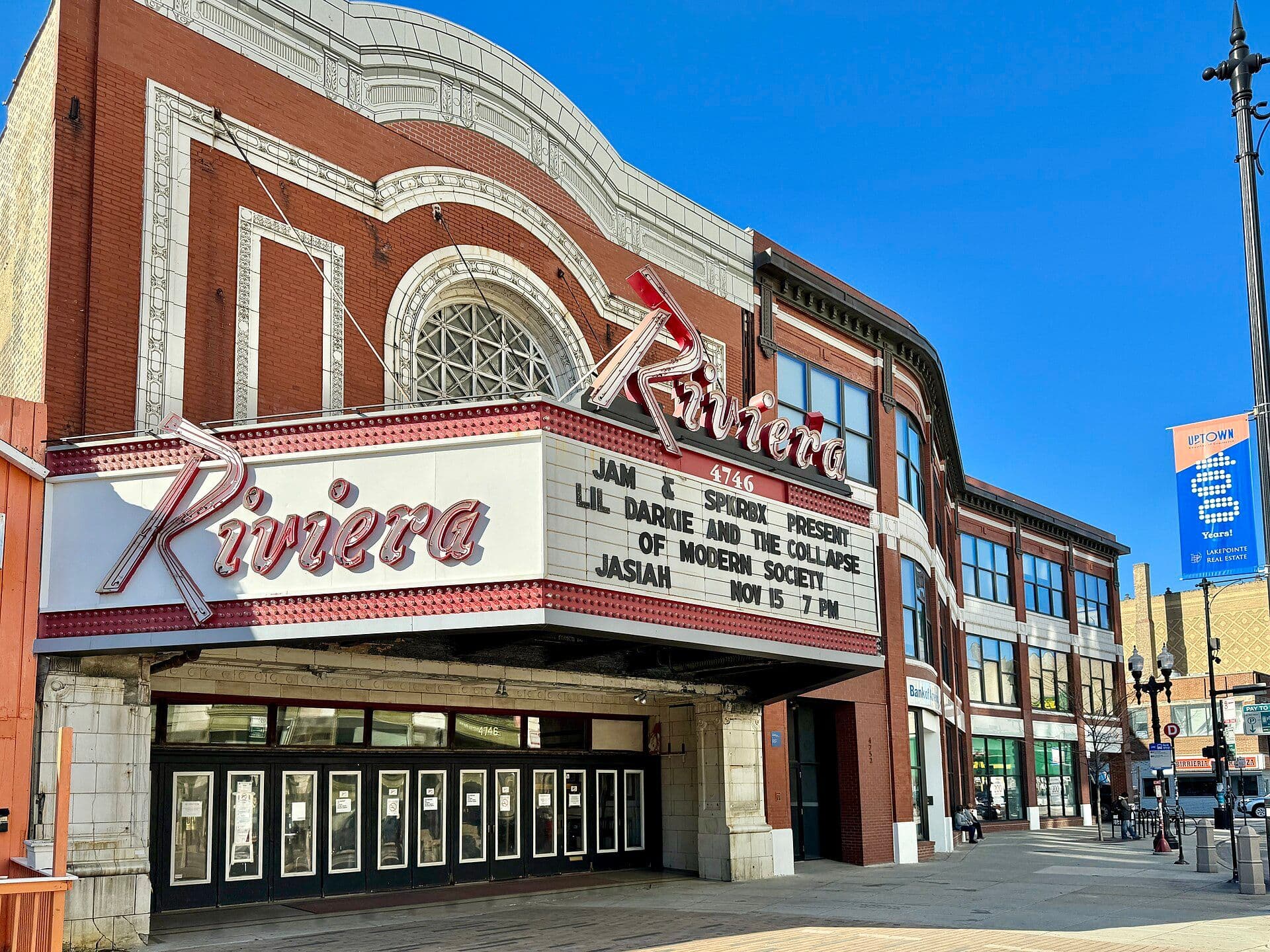 Renaissance Revival-style theater facade with ornate oval window and marquee