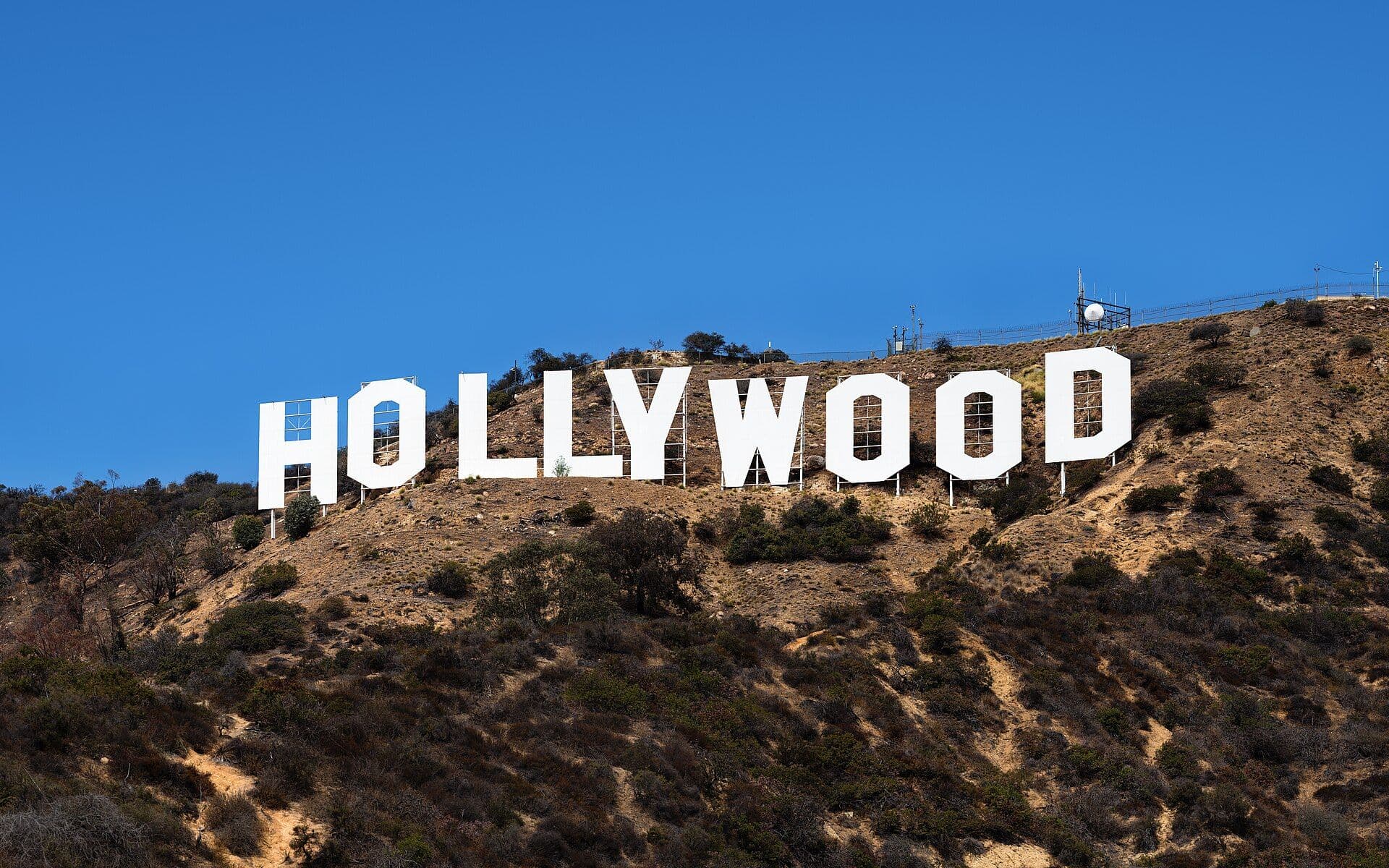 The Hollywood Sign on a hillside in Los Angeles under a clear blue sky