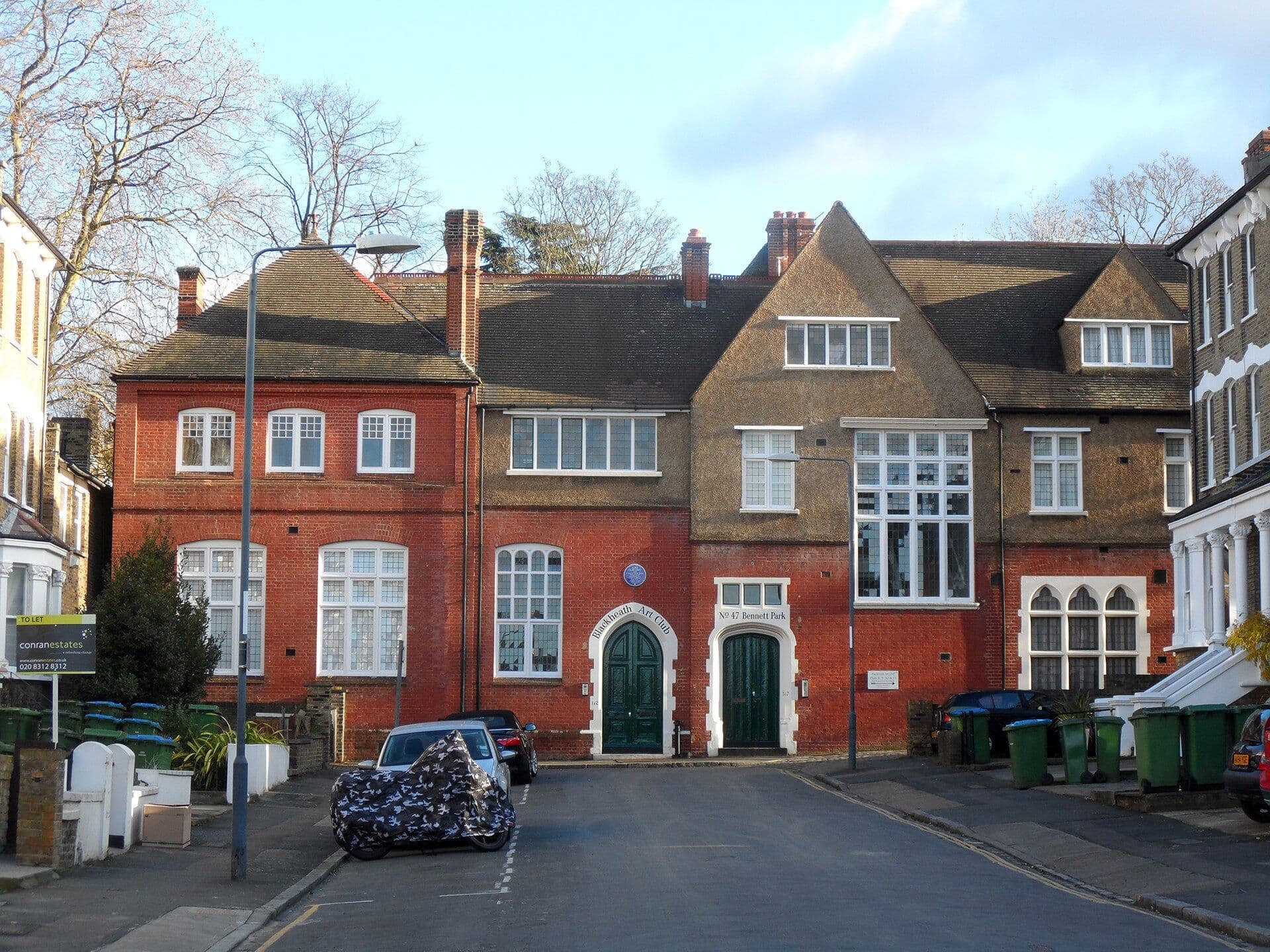 Red brick building with plaque marking the Crown Film Unit documentary studio