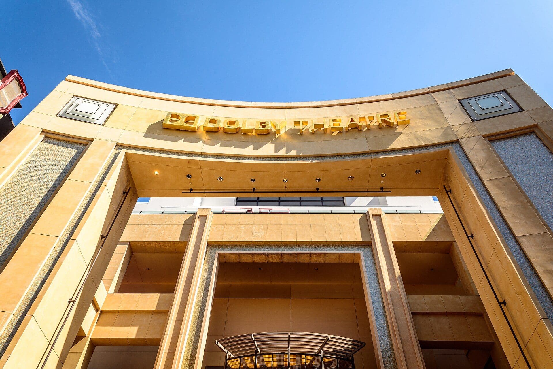 The Dolby Theatre building exterior with architectural facade against blue sky