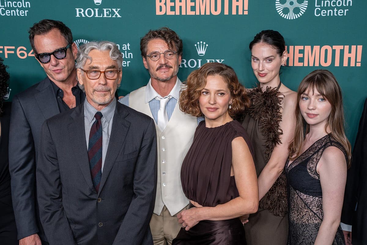 Tony Gilroy poses with cast members in front of a green Behemoth! and Film at Lincoln Center backdrop
