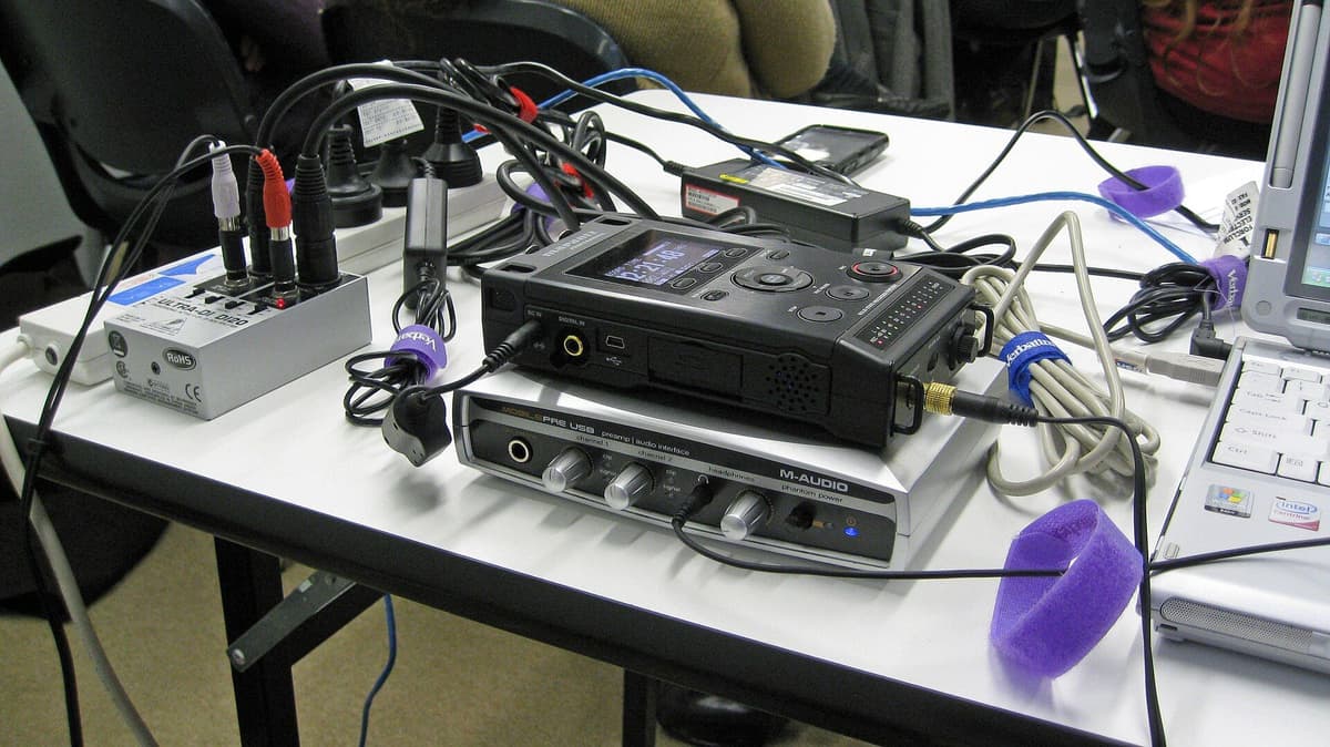 Audio recording and mixing equipment set up on a table for a podcast recording