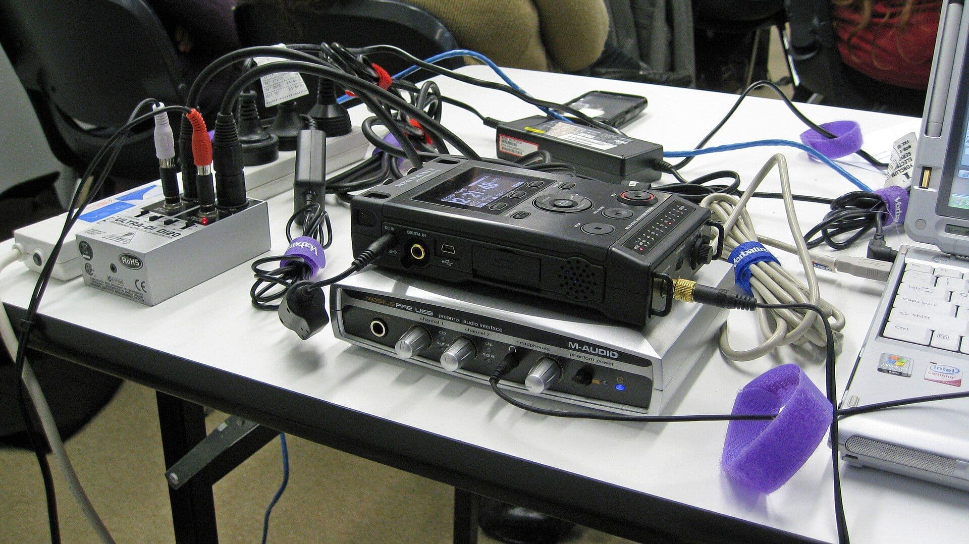 Audio recording and mixing equipment set up on a table for a podcast recording
